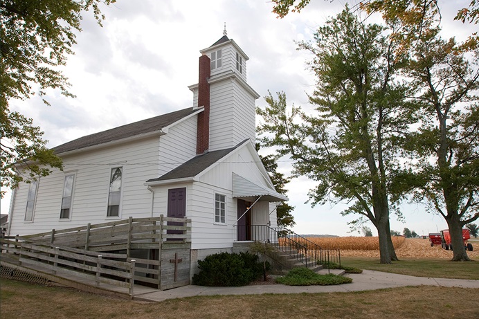 Corn is harvested from a field next to New Hope Bethel United Methodist Church outside Leipsic, Ohio, in 2010. Rural United Methodist churches are contributing to the economies of their communities up to $735,000 annually per congregation, according to a study funded by The Duke Endowment of rural congregations in North Carolina. File photo by Mike DuBose, UM News. Corn is harvested from a field next to New Hope Bethel United Methodist Church outside Leipsic, Ohio, in 2010. Rural United Methodist churches are contributing to the economies of their communities up to $735,000 annually per congregation, according to a study funded by The Duke Endowment of rural congregations in North Carolina. File photo by Mike DuBose, UM News.
