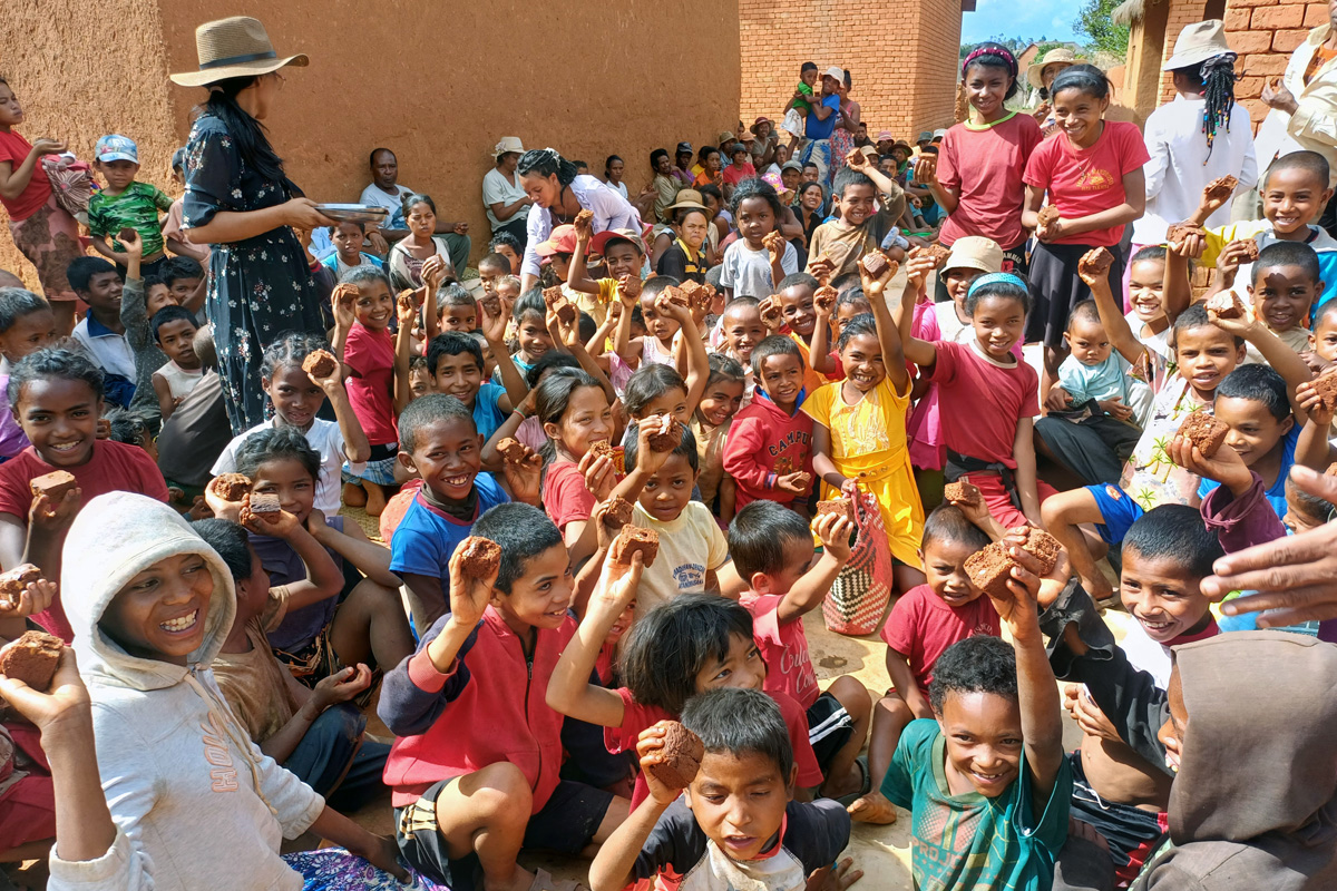 Children and youth show off the cake they received from visitors from Ambodifasika United Methodist Church in Faratanjona, Madagascar. The community faces food shortages due to climate change and other factors that have reduced crop production in the region. Photo by Esdras Rakotoarivony, UM News.