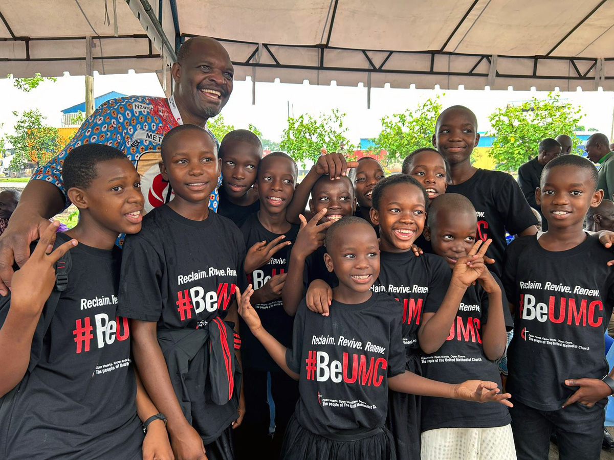 The Rev. Lloyd Nyarota smiles with a group of children from Changombe First United Methodist Church in Dar es Salaam, Tanzania, during the United Methodist Africa Forum meeting Jan 4-7. The orientation brought together about 150 delegates and alternates to General Conference to discuss issues of concern to the church in Africa. Photo courtesy of the Rev. Lloyd Nyarota.