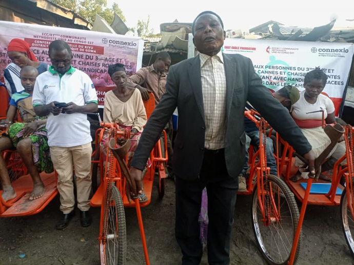 Samuel Kasororo stands with mobility aids provided by The United Methodist Church in eastern Congo. Kasororo, a United Methodist father of six, lost his right leg during war in 2006. The gift will enable him to continue his evangelism work, he said. Photo by Philippe Kituka Lolonga, UM News.