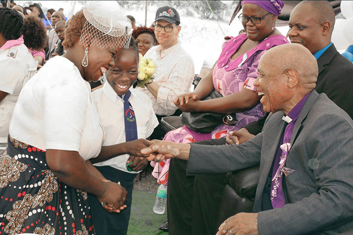 Naledi Mudzedze (center) and her mother greet Bishop Eben K. Nhiwatiwa during the dedication ceremony for the new Munyarari Mission Clinic in Munyarari, Zimbabwe. Mudzedze said afterward, “I have never (before) greeted my bishop.” Photo by Kudzai Chingwe, UM News.