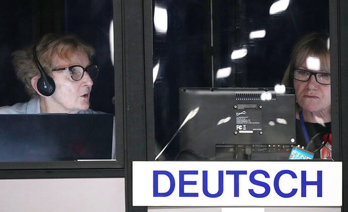Silvia Fosslien and Birgit Scherer-Wiedmeye interpret the conference into German during the United Methodist General Conference in Charlotte, N.C., on April 29. Photo by Larry McCormack, UM News.