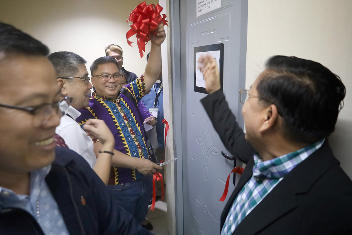 United Methodist Bishop Rodel M. Acdal (center) cuts the ribbon on a facility that will provide care and support for people living with HIV during a dedication service at Wesleyan University-Philippines Hospital in Cabanatuan City, Philippines. He is joined by Bishop Israel M. Painit (left) and Juanito Carlos Jr. (second from left), chair of the university's board of trustees. Photo courtesy of Wesleyan University-Philippines Hospital.