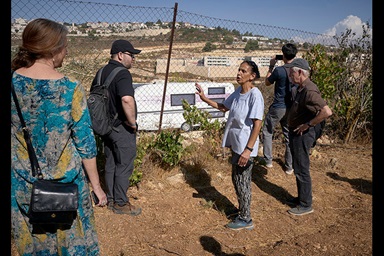 Amal Nassar shows a visiting delegation of U.S. church activists a trailer that has been moved onto land beside her family farm near Bethlehem. Known as the Tent of Nations, the farm is an educational and environmental center that sits on the last remaining Palestinian hilltop in the middle of the Gush Etzion settlement block near Bethlehem, in the occupied West Bank. The Christian Palestinian family remains under constant threat from settlers and the Israeli military. The trailer was moved there in May 2024, in what Nassar believes is an attempt to establish justification for expelling the Christian family. Photo by Paul Jeffrey, UM News. Amal Nassar shows a visiting delegation of U.S. church activists a trailer that has been moved onto land beside her family farm near Bethlehem. Known as the Tent of Nations, the farm is an educational and environmental center that sits on the last remaining Palestinian hilltop in the middle of the Gush Etzion settlement block near Bethlehem, in the occupied West Bank. The Christian Palestinian family remains under constant threat from settlers and the Israeli military. The trailer was moved there in May 2024, in what Nassar believes is an attempt to establish justification for expelling the Christian family. Photo by Paul Jeffrey, UM News.