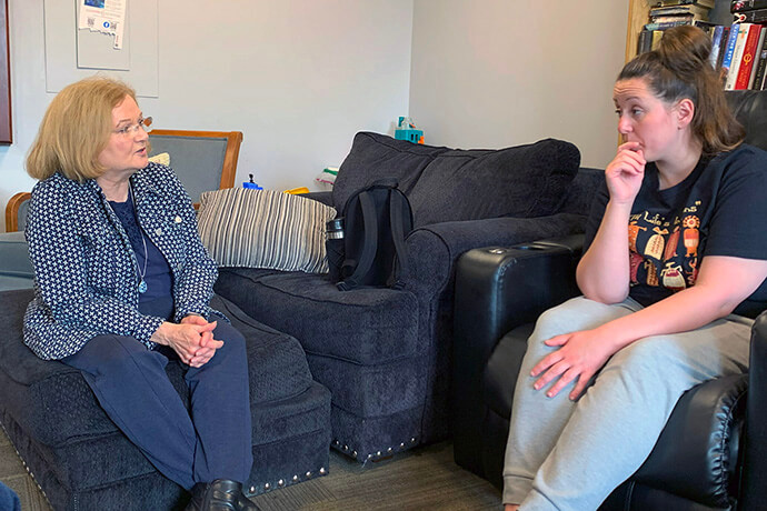 United Methodist Lori Chambers (left) meets with Haleign Baker, a resident of the Dove Recovery House for Women in Indianapolis. Among the home’s major supporters is St. Luke’s United Methodist Church, where Chambers is a lay leader. Photo by Joey Butler, UM News.