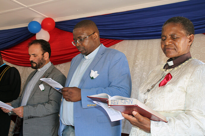 Bishop João Carlos Lopes of the Methodist Church in Brazil (left), the Rev. Samuel Dzobo and the Rev. Sophirina Sign, Zimbabwe East connectional ministries director, participate in the dedication ceremony for Dzobo United Methodist Church in Zimbabwe. Photo by Kudzai Chingwe, UM News.