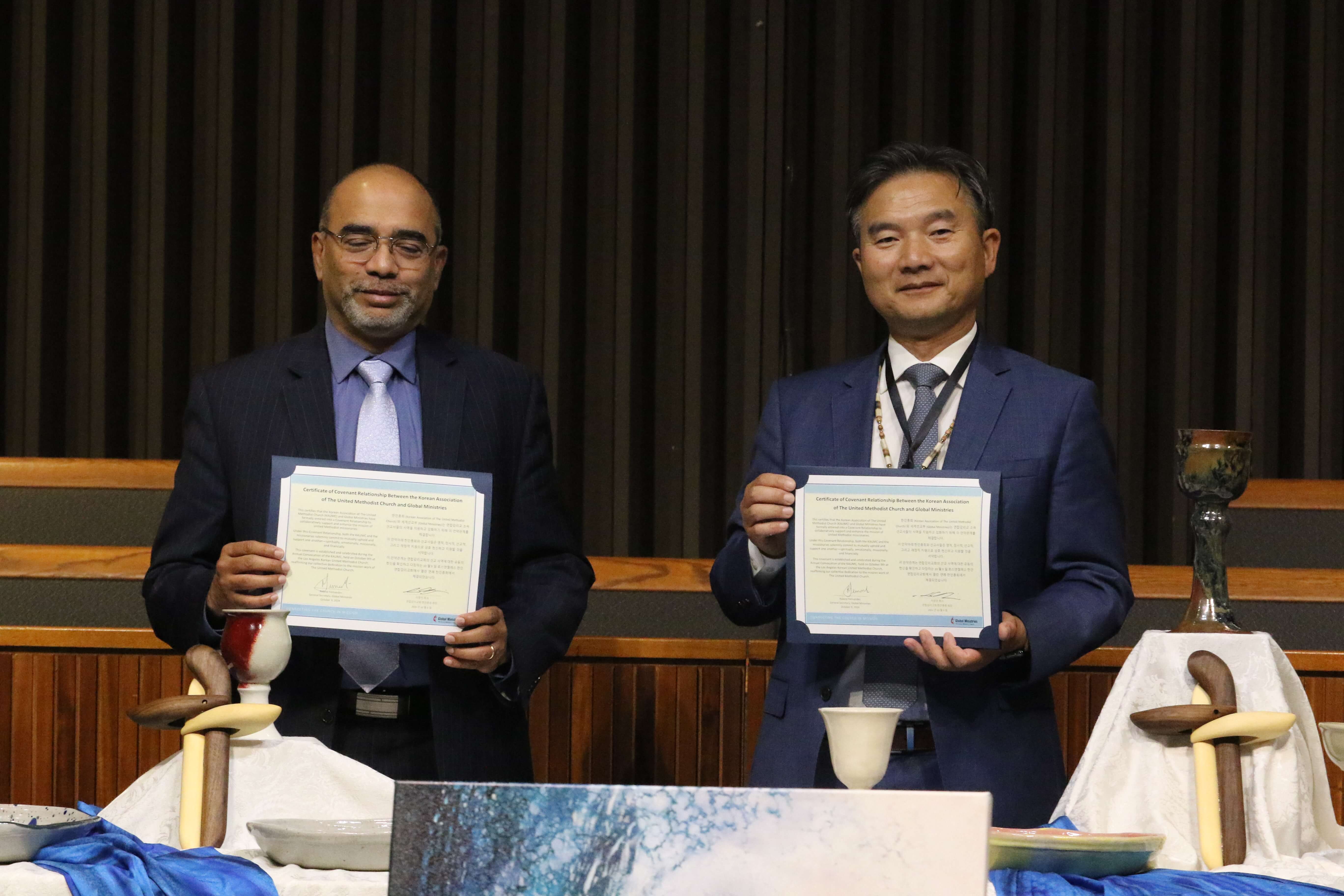2024 연합감리교회 한인총회 연차대회 셋째 날인 2024년 10월 9일, 로스앤젤레스 한인연합감리교회에서 한인총회와 연합감리교 세계선교부가 선교협약식(MISSION MOU)을 맺었다. (사진 왼쪽) 연합감리교 세계선교부 총무 롤랜드 퍼난데스와 한인총회 총회장 이창민 목사가 서명한 선교지원협약서를 들고 서 있다. 사진, 김응선 목사, 연합감리교뉴스.