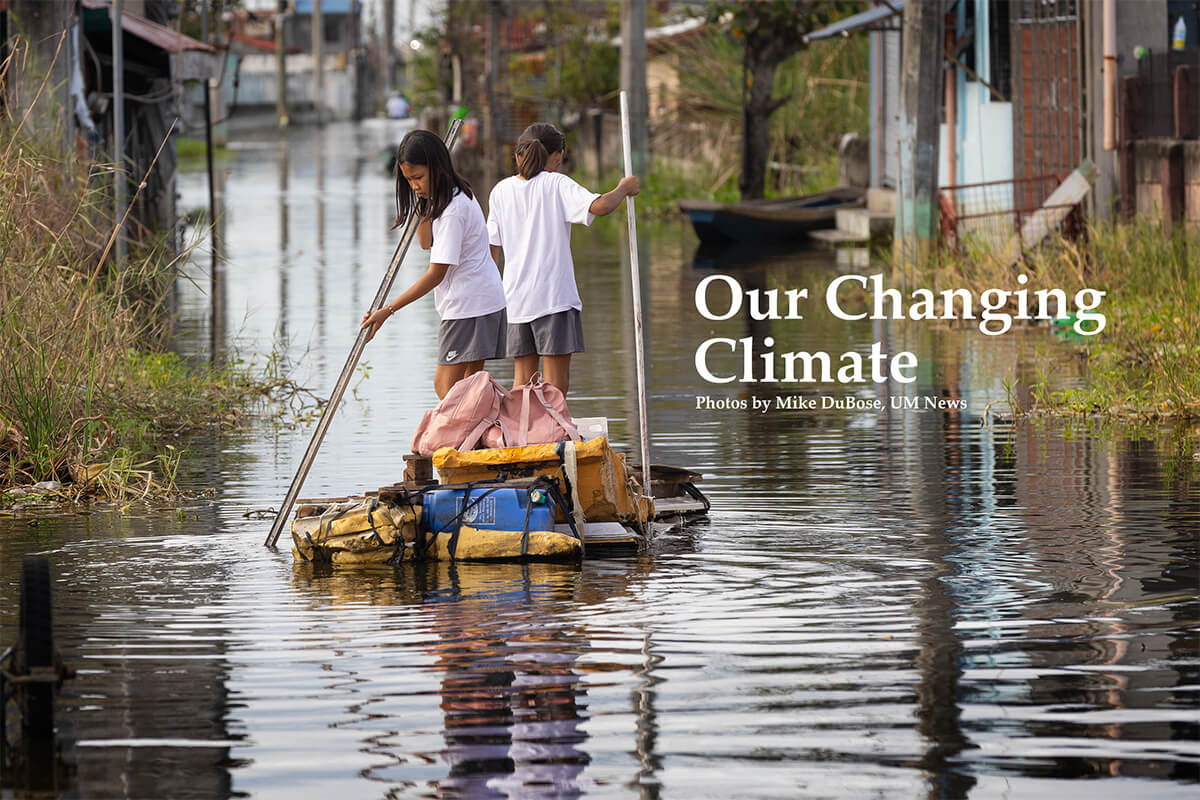 School has dismissed in Calumpit, Philippines, but the journey home for these schoolgirls is not on a bus or even on foot, but on a homemade raft they guide down a flooded street. Photo by Mike DuBose, UM News.