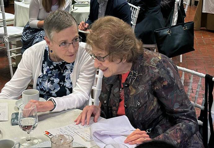 Kathleen Griffith (left), director and team lead for the United Methodist Board of Global Ministries’ Global Health unit, and Shirley Struchen (right), a retired United Methodist journalist, talk during the annual AIDS Interfaith Breakfast Sept. 25 in New York City. Struchen encourages local churches to remember those living with HIV globally as they light the Advent candle on the first Sunday of Advent on Dec. 1, which is also World AIDS Day. Photo by the Rev. Donald E. Messer, UM News.