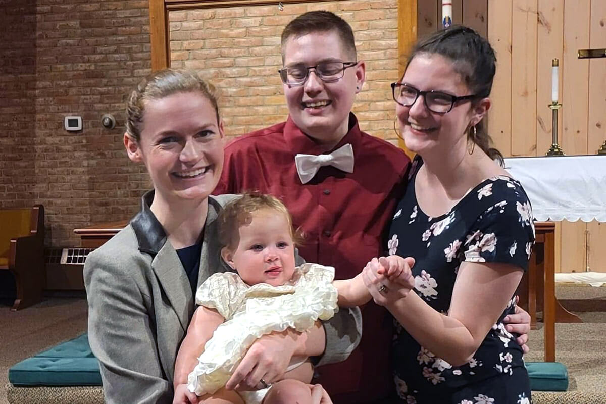 The Rev. Madison Long Ailinger holds Tee’na as her parents look on after her baptism at Christ United Methodist Church in Staunton, Va. The parish-focused pastor is creating a sense of belonging for those living around the church, whether or not they attend worship. Photo courtesy of Ailinger.   