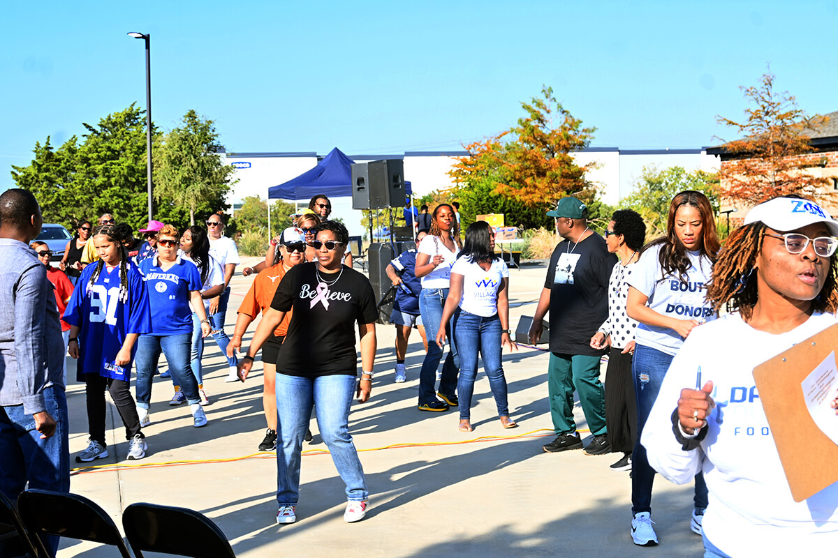 Members of The Village United Methodist Church in DeSoto, Texas, dance during an Oct. 27 worship service in the parking lot of the church. The church hosts a tailgate-like event when the Dallas Cowboys play at home. Photo by Jim Patterson, UM News.