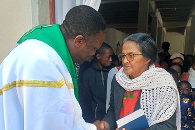 O Rev. Éric Kalumba cumprimenta um membro da igreja após o culto na Igreja Metodista Unida de Ambodifasika em Ambodifasika, Madagascar. Kalumba, um missionário dos Ministérios Globais da Metodista Unida, está responsabilizado de plantar novas igrejas Metodistas Unidas pela ilha. Foto de Esdras Rakotoarivony, Notícias da MU.