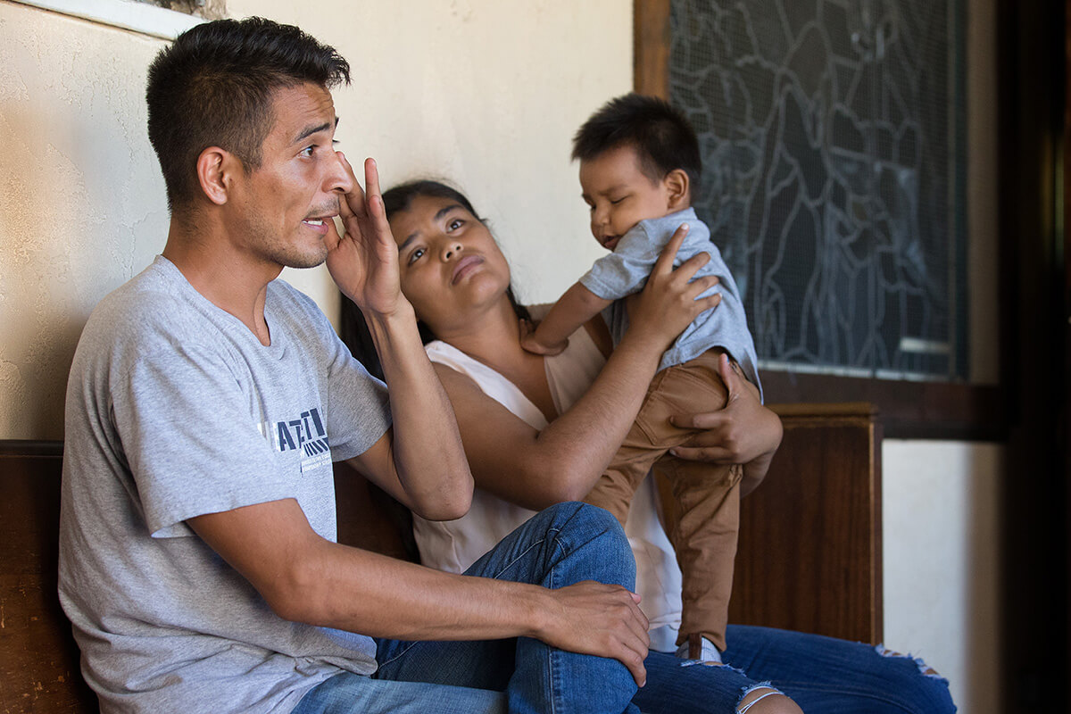 A couple recounts the threats of violence that caused them to flee Mexico with their 1-year-old child in this 2018 file photo. The family took shelter at the Christ United Methodist Ministry Center in San Diego while seeking asylum. United Methodists continue to speak out against Trump administration policies that target undocumented immigrants. Photo by Mike DuBose, UM News.