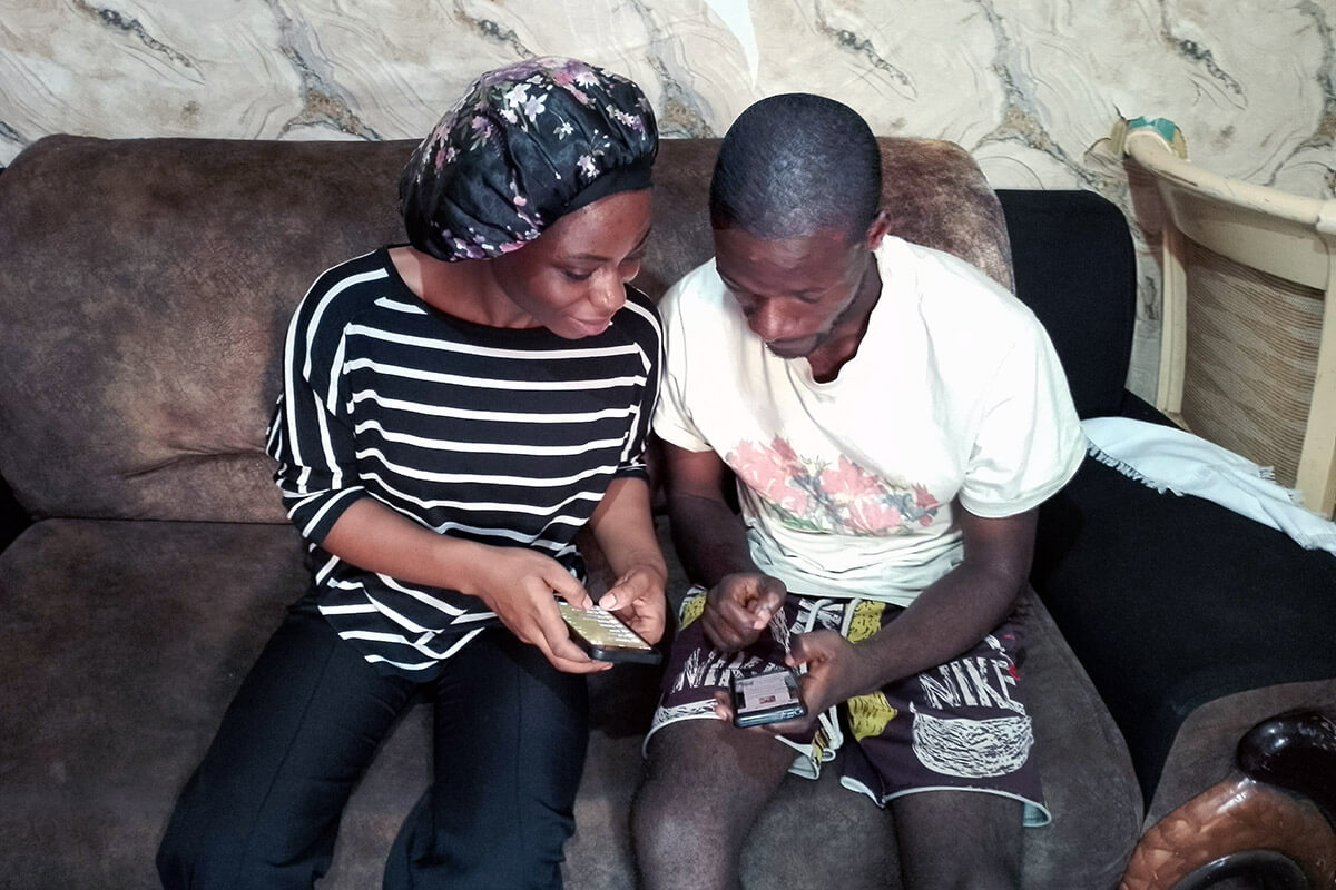 United Methodists Joséphine Kingombe and Masudi Kansilembo read messages sent to their phones by pastors in Bukavu, Congo. Church leaders are sending support to help the faithful during growing insecurity in the region. Photo by Philippe Kituka Lolonga, UM News.