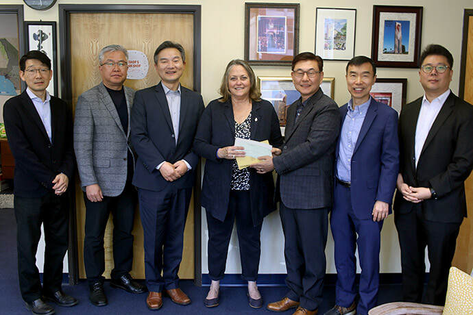 Bishop Dottie Escobedo-Frank receives more than $18,000 in support for wildfire recovery from executive committee members of the Association of the Korean United Methodist Church of the California-Pacific Conference on Feb. 24. The donations were collected from Korean congregations and non-Korean congregations led by Korean pastors. From left are the Revs. Christian Jung, Jacob Lee and Changmin Lee, Bishop Escobedo-Frank, and the Revs. Brian Lee, Sungki Lee and Jay Jeon. Photo by the Rev. Thomas E. Kim, UM News.