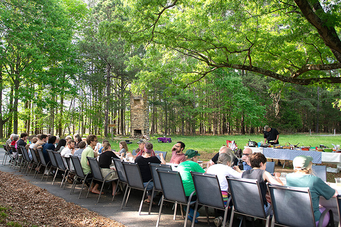 Periodic mass meals are held at Spring Forest to bring people together as part of its goal of creating community. The 23-acre property in Hillsborough, N.C., includes a working farm with goats, chickens and various crops. Usually 11 or 12 people are living at the “new monastic community” at any given time. Photo by Justin Nygren of Spring Forest.