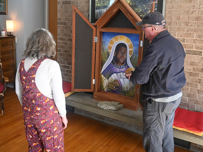 The Rev. Elaine A. Heath, abbess of Spring Forest, shows a painting of Mary holding Jesus to a visitor at her home on the 23-acre compound that is designed as an “intentional faith community.” Photo by Jim Patterson, UM News.