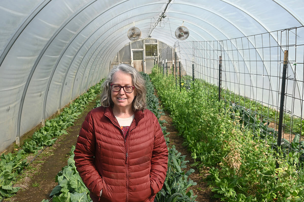 The Rev. Elaine A. Heath, former dean at Duke Divinity School and abbess at Spring Forest in Hillsborough, N.C., stands amid some of the crops at the farm portion of the 23-acre property that also contains two homes, large outdoor tables for community meals and a stage for entertainment. The monastic community is in stark contrast to Heath’s difficult childhood. Photo by Jim Patterson, UM News.