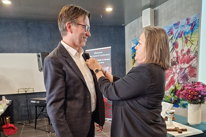 The Rev. Knut Refsdal receives the episcopal pin from Bishop Dottie Escobedo-Frank after being elected a United Methodist bishop on April 4 at the Northern Europe and Eurasia Central Conference in Copenhagen, Denmark. Refsdal, a pastor in Norway, was elected on the 26th ballot. Photo by Karl Anders Ellingsen, UM News.  The Rev. Knut Refsdal receives the episcopal pin from Bishop Dottie Escobedo-Frank after being elected a United Methodist bishop on April 4 at the Northern Europe and Eurasia Central Conference in Copenhagen, Denmark. Refsdal, a pastor in Norway, was elected on the 26th ballot. Photo by Karl Anders Ellingsen, UM News.
