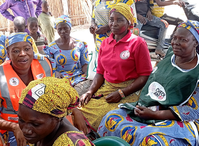Nurses Jemima Anthiah (left) and Maimuna Eliphaz (right) provide medications and counseling on proper health management to women at Yapilo Village in Gombe State on March 29. The free health services were organized by the Northern Nigeria Conference’s women’s organization. Photo by Ibrahim Babangida, UM News.