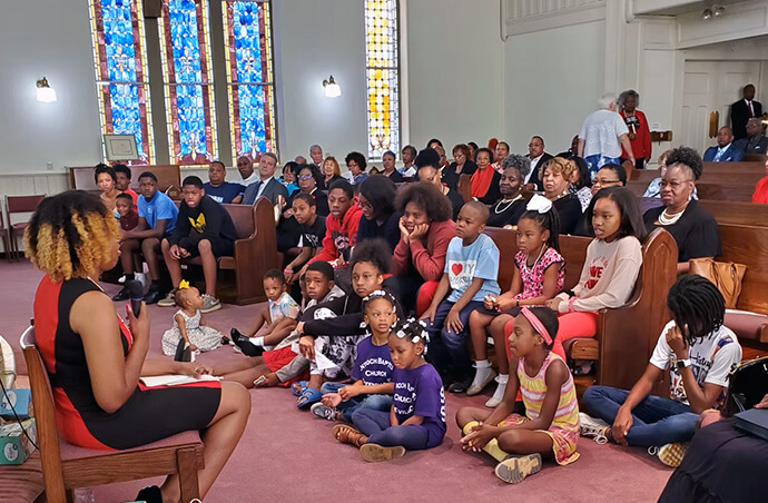 Children and adults listen to a special message at John Wesley United Methodist Church in Greenville, S.C., the city’s oldest Black United Methodist Church. File photo courtesy of John Wesley United Methodist Church.