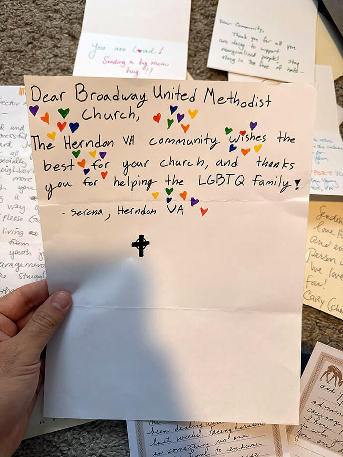 The Rev. Rushing Kimball holds up one of the cards he has received in solidarity with him and his congregation, Broadway United Methodist Church, which is among the Orlando, Fla., congregations facing threats from people opposed to LGBTQ inclusion. The church has friends in Herndon, Virginia, near Washington, D.C. Photo courtesy of Kimball, Broadway United Methodist Church.