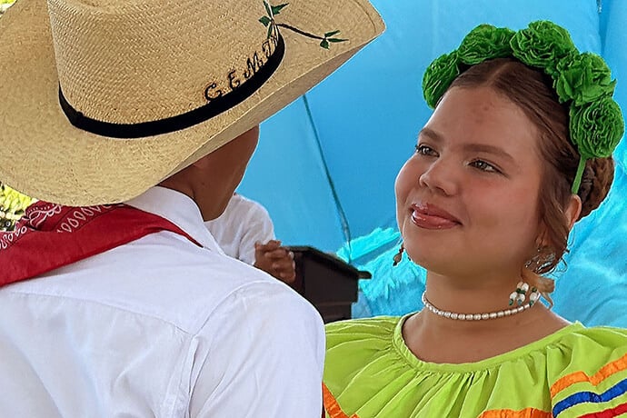 Students at the John Wesley Methodist Educational Center welcome guests of the United Methodist Mission in Honduras with a dance performance. The church-supported school is an alternative for local youth in Ciudad España, where poverty and a lack of alternatives lead many young people to be recruited by criminal gangs. Photo by the Rev. Gustavo Vasquez, UM News.