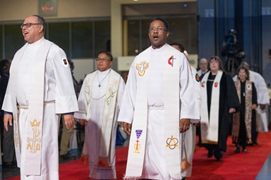 A procession of United Methodist bishops leads opening worship at the 2024 United Methodist General Conference on April 23, 2024, in Charlotte, N.C. The board of The United Methodist Church’s finance agency voted to give bishops a 3% retroactive salary increase. The move comes after bishops in December asked to forgo a raise in 2025 amid tight budgets denomination-wide. File photo by Mike DuBose, UM News. A procession of United Methodist bishops leads opening worship at the 2024 United Methodist General Conference on April 23, 2024, in Charlotte, N.C. The board of The United Methodist Church’s finance agency voted to give bishops a 3% retroactive salary increase. The move comes after bishops in December asked to forgo a raise in 2025 amid tight budgets denomination-wide. File photo by Mike DuBose, UM News.