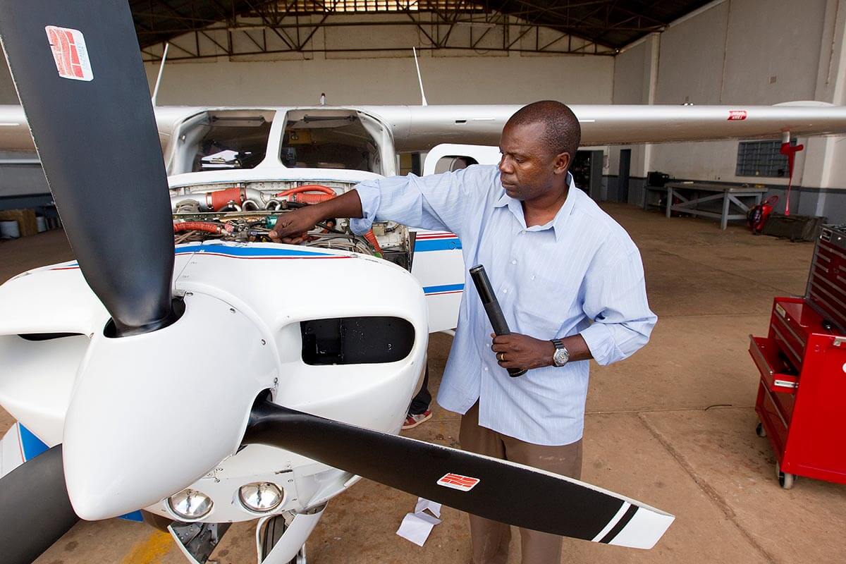 Missionary pilot and mechanic Gaston Ntambo readies the Wings of the Morning plane for its next flight from the international airport in Lubumbashi, Democratic Republic of the Congo. Photo by Mike DuBose, UM News.