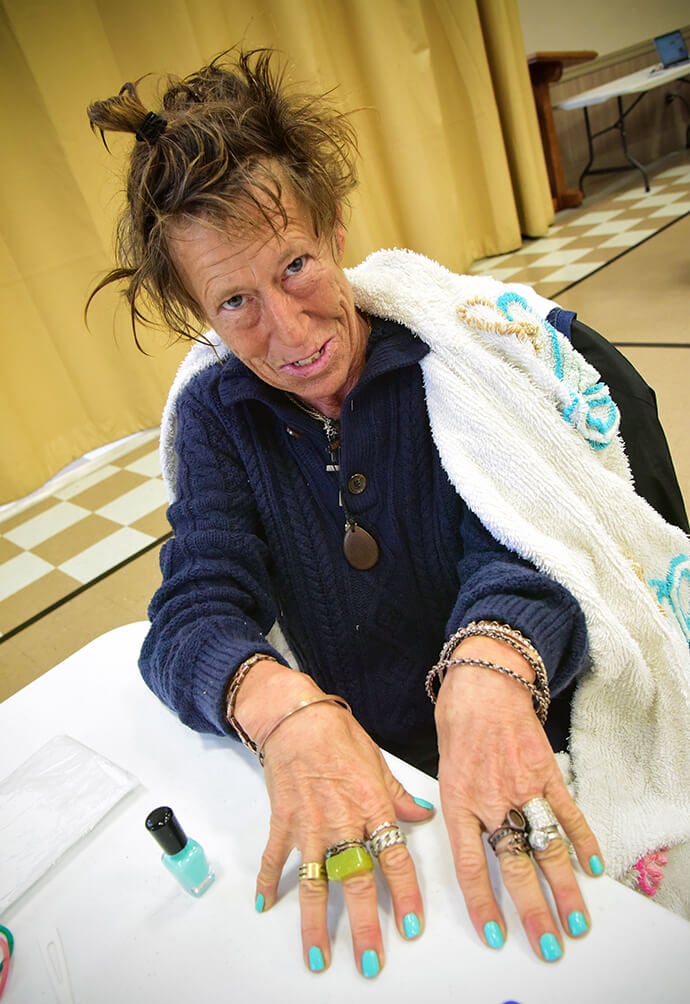 Carla shows off her new nail color March 28 at First United Methodist Church in Austin, Texas. She and other unhoused women are welcome each Friday at the church, where they can enjoy some sustenance and small luxuries. Photo by Andrea Turner, UM News.