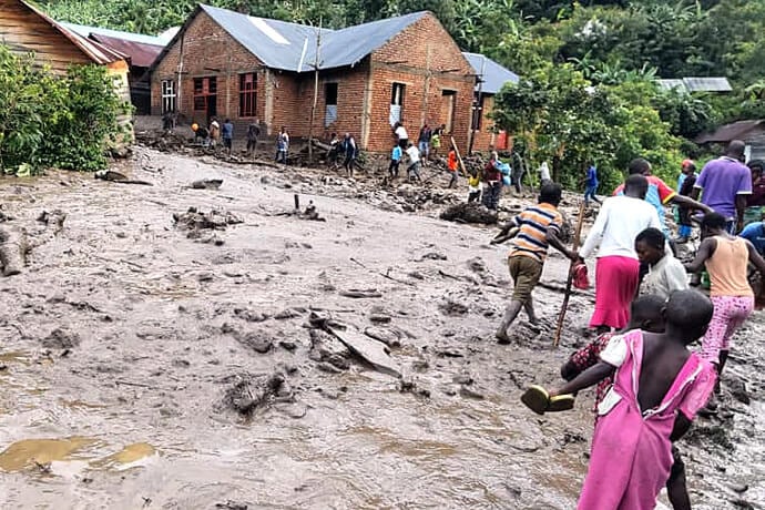 Children and adults cross a mud-filled street in Kasaba, Congo, where flooding has killed at least 110 people, including five United Methodists, and destroyed hundreds of homes. A local United Methodist church was destroyed by floodwaters, affecting some 300 United Methodists. Photo courtesy of the Ecclesiastical District of Fizi. Children and adults cross a mud-filled street in Kasaba, Congo, where flooding has killed at least 110 people, including five United Methodists, and destroyed hundreds of homes. A local United Methodist church was destroyed by floodwaters, affecting some 300 United Methodists. Photo courtesy of the Ecclesiastical District of Fizi.