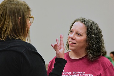 The Rev. Cathy Stone (right), associate pastor of First United Methodist Church of Austin, chats with a volunteer March 28 at the church. Stone is the driving force behind the church’s efforts to cater to the needs of unhoused people. Each Friday, volunteers provide women with food and pampering. Photo by Andrea Turner, UM News. The Rev. Cathy Stone (right), associate pastor of First United Methodist Church of Austin, chats with a volunteer March 28 at the church. Stone is the driving force behind the church’s efforts to cater to the needs of unhoused people. Each Friday, volunteers provide women with food and pampering. Photo by Andrea Turner, UM News.