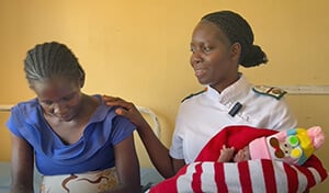 A nurse at The United Methodist Church’s Chikwizo rural health clinic’s mother’s shelter in Zimbabwe holds a newborn baby. Video image by Eveline Chikwanah, UM News.