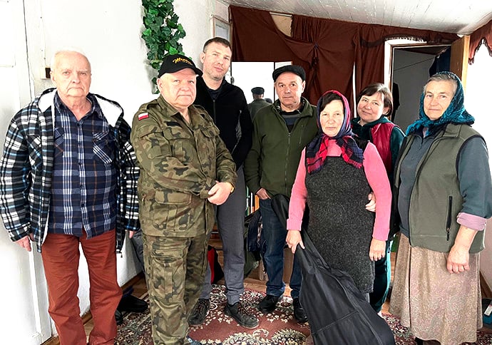 Jarosław Bator (second from left), pastor of Puławy United Methodist Church in Poland, visits with Ukrainian citizens during a trip to the war-torn nation. Bator visits Ukraine monthly, preaching regularly at two locations. Photo courtesy of Jarosław Bator.