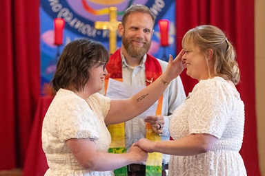 Lindsey Dye pauses to wipe away Laura Smotherman’s tears as the couple renew their wedding vows during a service for three gay couples June 8 at Edgehill United Methodist Church in Nashville, Tenn. Officiating is the Rev. Eric Mayle, Edgehill’s senior pastor. Photo by Mike DuBose, UM News. Lindsey Dye pauses to wipe away Laura Smotherman’s tears as the couple renew their wedding vows during a service for three gay couples June 8 at Edgehill United Methodist Church in Nashville, Tenn. Officiating is the Rev. Eric Mayle, Edgehill’s senior pastor. Photo by Mike DuBose, UM News.