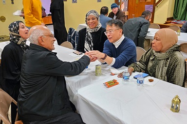 The Rev. Mark Salvacion (right center), pastor of St. Luke United Methodist Church in Bryn Mawr, Pa., holds the hands of Ahmad Abdel-Hamid, president of As-Salaam Islamic Society, after a fellowship feast March 15 at the church, during the holy month of Ramadan. Photo by John W. Coleman, UM News. The Rev. Mark Salvacion (right center), pastor of St. Luke United Methodist Church in Bryn Mawr, Pa., holds the hands of Ahmad Abdel-Hamid, president of As-Salaam Islamic Society, after a fellowship feast March 15 at the church, during the holy month of Ramadan. Photo by John W. Coleman, UM News.