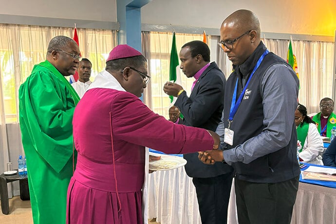 The Most Rev. Paul Kwabena Boafo, president of the Africa Methodist Council, serves communion elements to Ndzulo Tueche, staff of The United Methodist Church’s General Council on Finance and Administration, during the Africa heads of conferences summit held May 14-19 in Nairobi, Kenya. The meeting aimed to create space for Wesleyan bishops to map a way forward for the Methodism movement in Africa. Photo by Eveline Chikwanah, UM News.