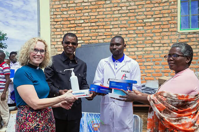 Bishop Emmanuel Sinzohagera (second from left) and Niyoyankunze Philemon, head of the Gahambwe Health Center (second from right), receive a batch of medical equipment donated by the government from Dr. Lyduine Baradahana, health minister (right), in the presence of the Rev. Dee Stickley-Miner (left) of Global Ministries. This handover symbolizes the Burundian government's support for the project led by The United Methodist Church. Photo by Jérôme Ndayisenga, UM News.