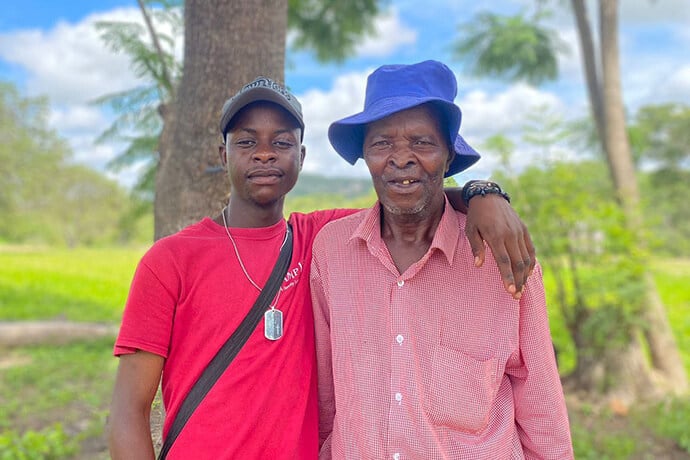 Panashe Banda poses with his uncle, James Chadamoyo Chipuka, at their rural homestead in Chikomo village in the Murewa District of Zimbabwe. Banda received the Bishop’s Episcopal Scholarship, which covered his costs to attend Africa University. “I hope to carry forward the same spirit of generosity and purpose that the church exemplified,” Banda said. Photo by Chenayi Kumuterera, UM News.