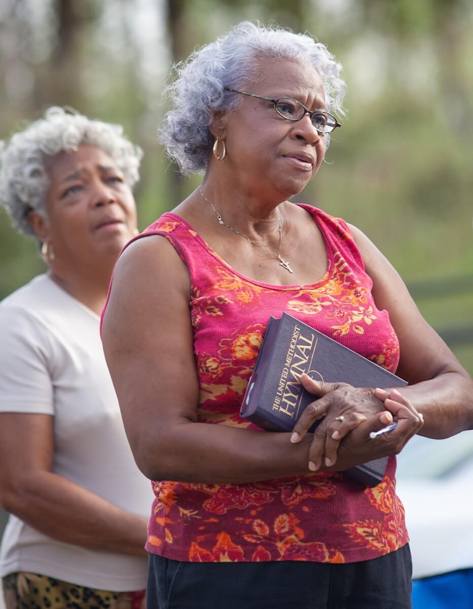Atha Brown (right) and Victoria Alfred sing “Amazing Grace” during an outdoor worship service at Hartzell Mt. Zion United Methodist Church in Slidell, La., where the sanctuary was flooded by storm surge from Hurricane Katrina. A UMNS photo by Mike DuBose
