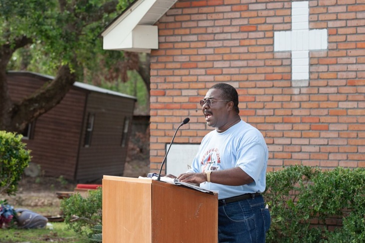 The Rev. Ernest Scott leads an outdoor worship service at Hartzell Mt. Zion United Methodist Church in Slidell, La., where the sanctuary was flooded by storm surge from Hurricane Katrina. A UMNS photo by Mike DuBose