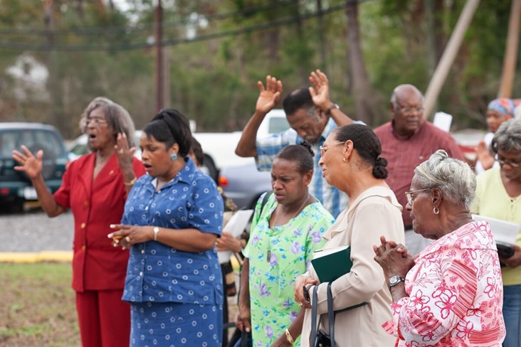 Members of Hartzell Mt. Zion United Methodist Church in Slidell, La., worship in the church parking lot following Hurricane Katrina. Photo by Mike DuBose, UM News.