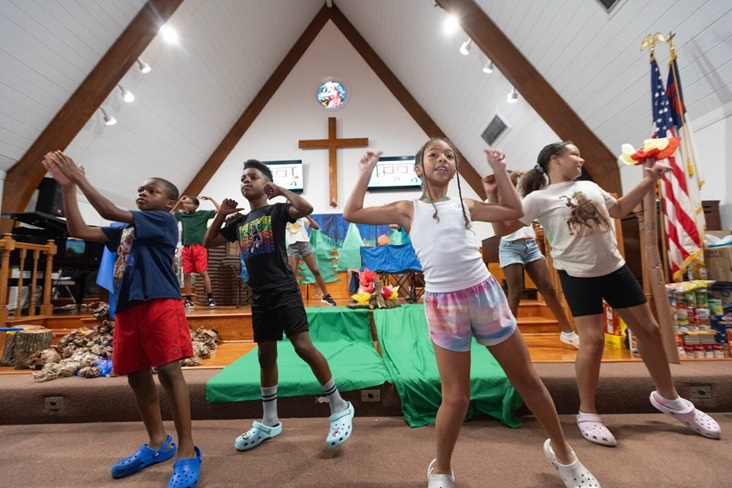 Children dance during vacation Bible school at Hartzell Mt. Zion United Methodist Church in Slidell, La. From left are Kyree Nichols, Zion Stevenson, Reagan Ordogne and Skylar Faulk. Photo by Mike DuBose, UM News.
