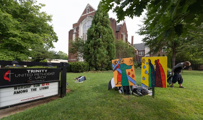Persons experiencing homelessness often sleep on the lawn outside Trinity United Methodist Church in Asheville, N.C. The church houses the Deep Time ministry, which recruits former inmates to roast coffee and operate a small coffee shop.