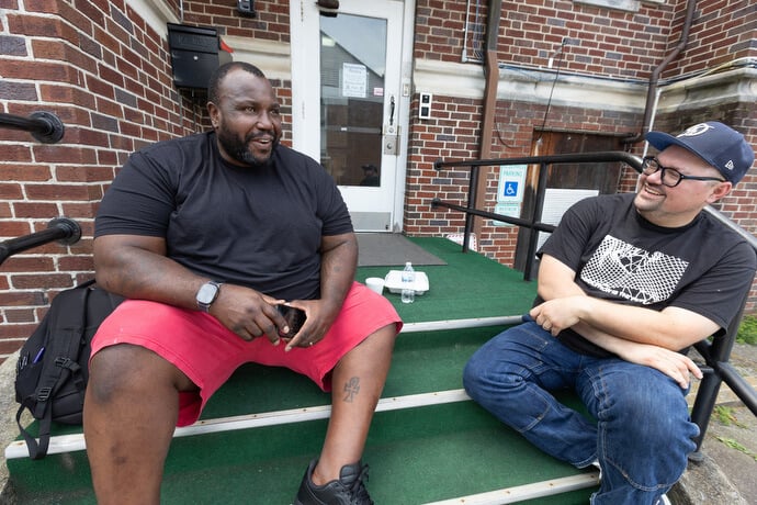 The Rev. Dustin Mailman (right) visits with Gene Jettison who serves on the advisory committee at Deep Time.