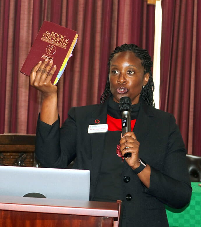 The Rev. Aleze M. Fulbright, who serves as the secretary of General Conference, holds up the 2020/2024 Book of Discipline during a discussion with secretaries of annual conferences at GCFA training at Africa University. The group talked about the importance of compiling and sharing journals with accurate membership information. Photo by Eveline Chikwanah, UM News.