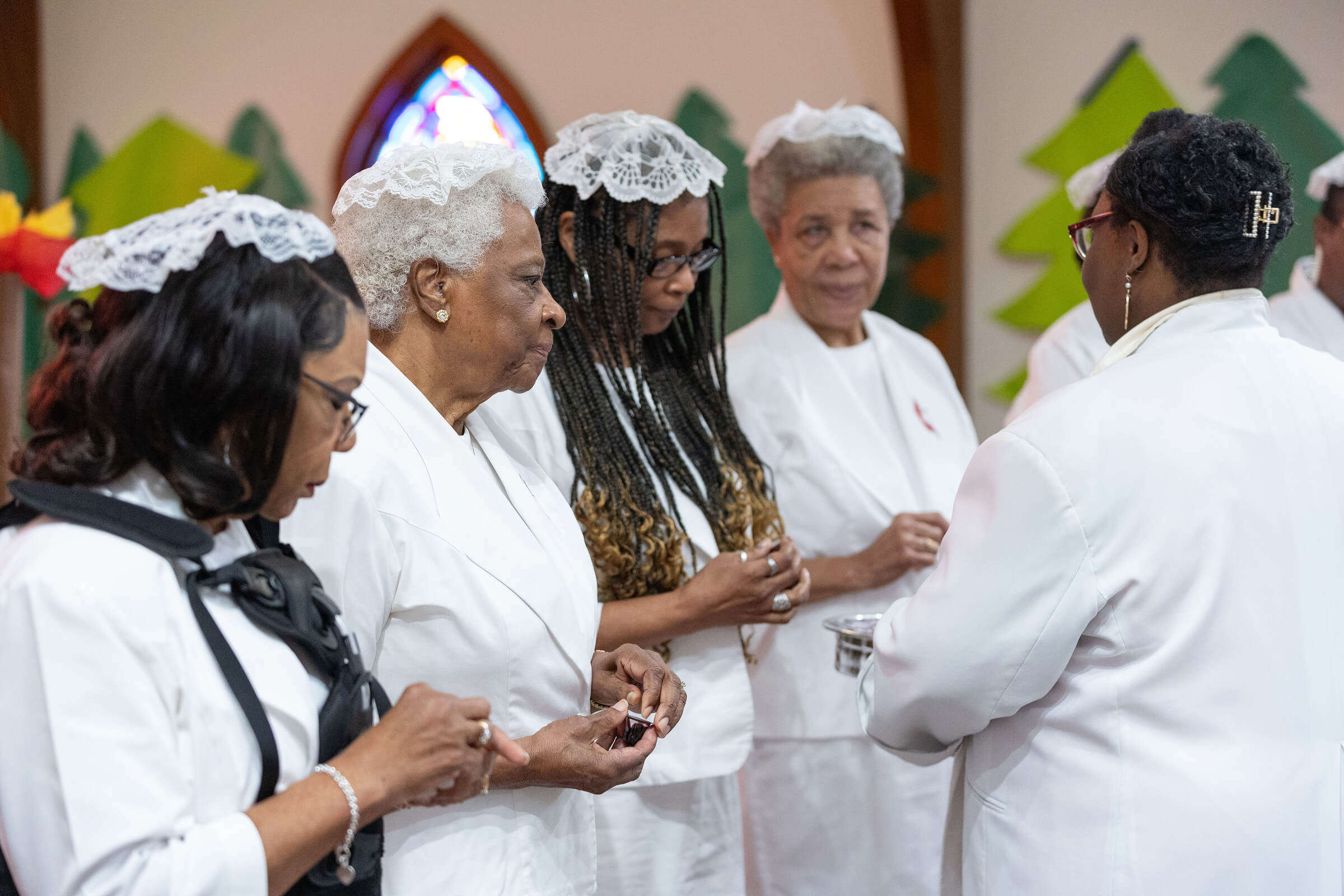 Communion stewards receive the elements from the Rev. Tiffanie Postell (right) during worship at Hartzell Mt. Zion United Methodist Church in June. From left are Annette Holloway, Atha Brown, Penny Brown and Viola Miller. Communion stewards receive the elements from the Rev. Tiffanie Postell (right) during worship at Hartzell Mt. Zion United Methodist Church in June. From left are Annette Holloway, Atha Brown, Penny Brown and Viola Miller.