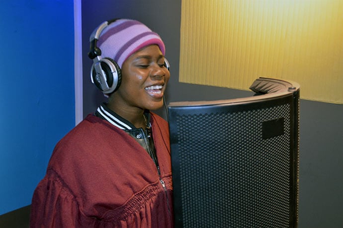 Belodie Musombu sings during a recording session at Jerusalem United Methodist Church’s new studio in South Congo. Musombu is a member of the church’s New Covenant United Methodist Choir, which raised nearly $50,000 to build the modern recording studio. It includes a soundproof booth, high-quality microphones and other equipment. Photo by Jenovic Mandandj, UM News.