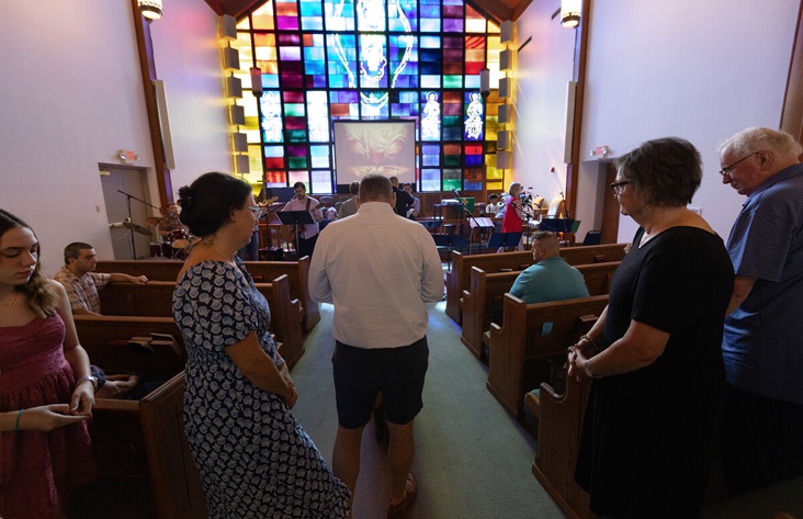 Parishioners walk to the altar to receive Holy Communion at St. Luke’s United Methodist Church. Photo by Mike DuBose, UM News.