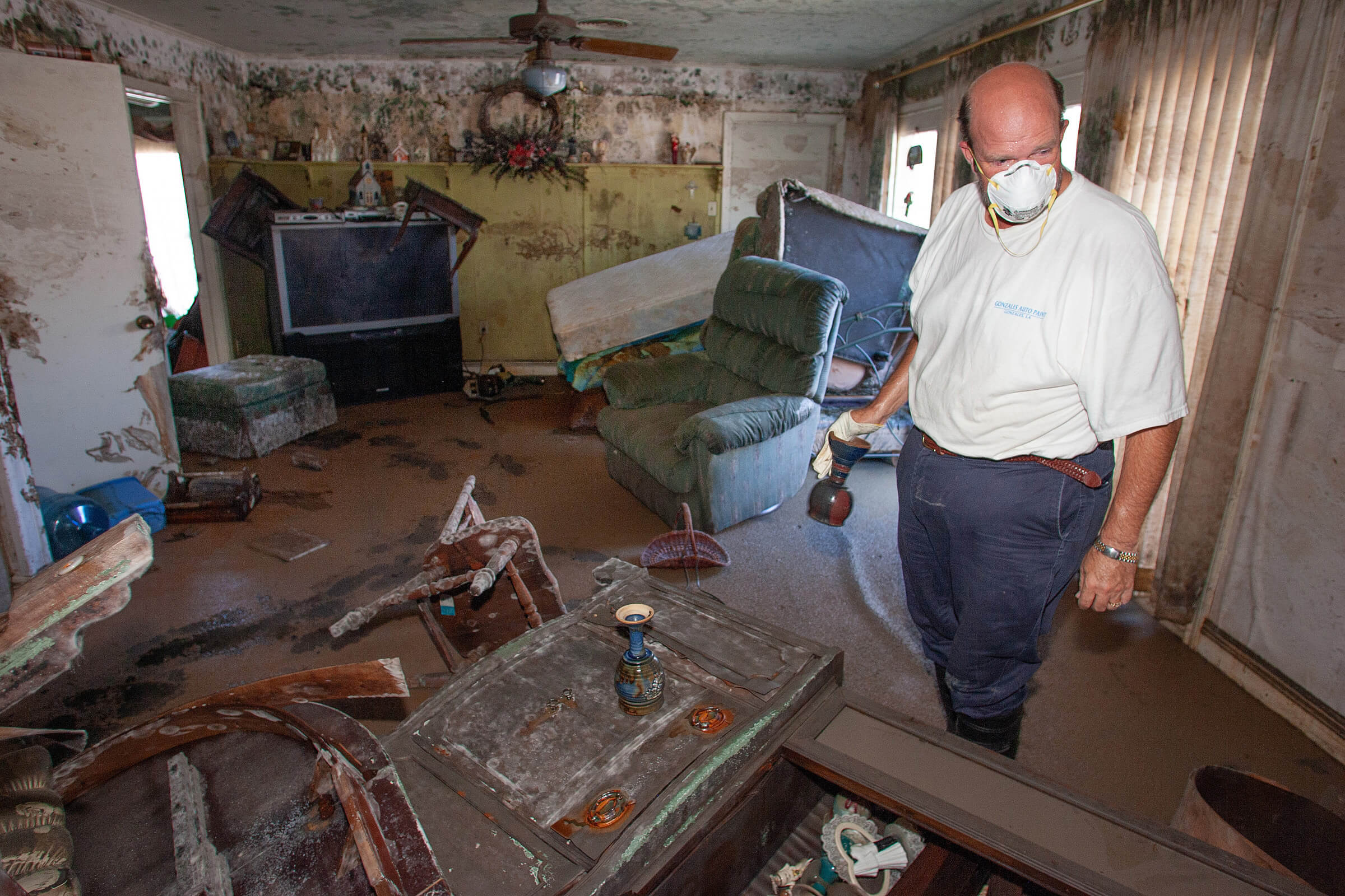 The Rev. Chris Blanchard salvages communion chalices for his friend, the Rev. Darryl Tate, from Tate’s parsonage in the Lakeview neighborhood of New Orleans following Hurricane Katrina. The chalices, a gumbo pot and the top to Tate’s wedding cake were all that could be salvaged from the home. Tate’s church, St. Luke’s United Methodist, sustained heavy damage. Photo by Mike DuBose, UM News. The Rev. Chris Blanchard salvages communion chalices for his friend, the Rev. Darryl Tate, from Tate’s parsonage in the Lakeview neighborhood of New Orleans following Hurricane Katrina. The chalices, a gumbo pot and the top to Tate’s wedding cake were all that could be salvaged from the home. Tate’s church, St. Luke’s United Methodist, sustained heavy damage. Photo by Mike DuBose, UM News.